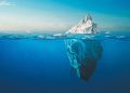 Amazing white iceberg floats in the ocean with a view underwater. Hidden Danger and Global Warming Concept. Tip of the iceberg. Half underwater. Greenland